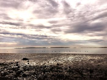 Scenic view of beach against sky during sunset