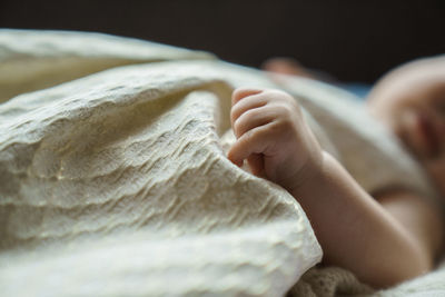 Midsection of baby girl lying at home