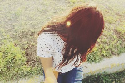 Rear view of woman standing on field