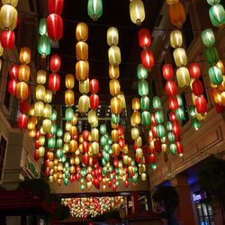 Low angle view of illuminated lanterns hanging at night