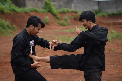 Young men practicing karate outdoors