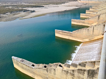 High angle view of dam on sea against sky