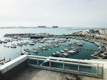 High angle view of marina at harbor against sky