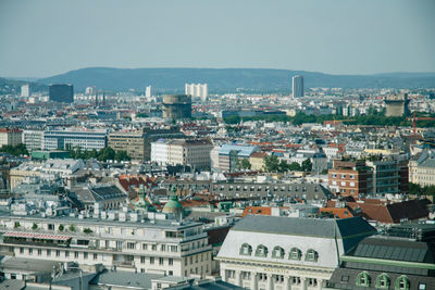 High angle view of buildings in city against clear sky