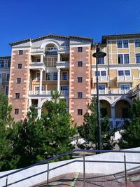 Low angle view of buildings against clear blue sky