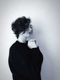 Woman looking away against white background