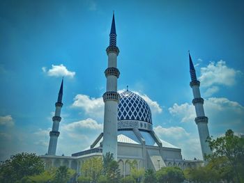 Low angle view of building against cloudy sky