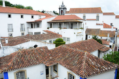 High angle view of houses in town against sky