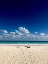 Scenic view of beach against blue sky