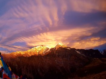 Scenic view of snowcapped mountains against sky during sunset