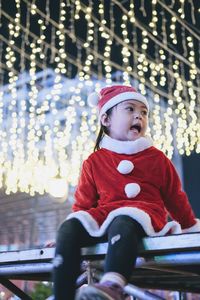 Portrait of boy looking away in santa suit