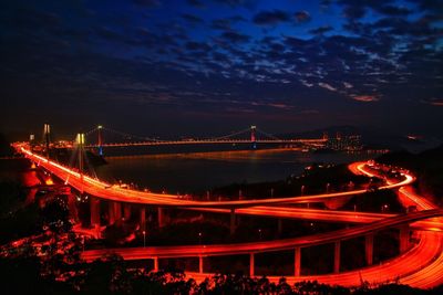 High angle view of illuminated city against sky at night