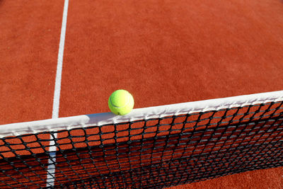 Yellow tennis ball on the floor