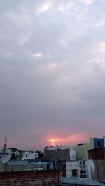 View of cityscape against cloudy sky