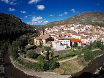 High angle view of townscape and mountains against sky