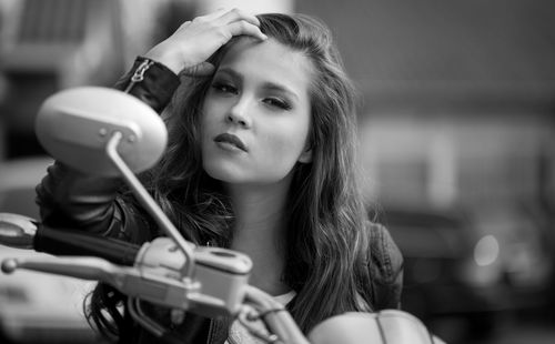 Close-up of young woman sitting on motorcycle