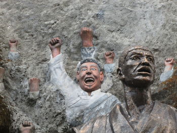 Close-up of statues against wall