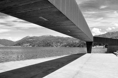 Bridge over river against cloudy sky