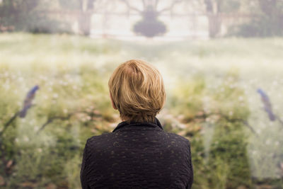 Rear view of woman against blurred background