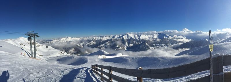 Scenic view of snow covered mountains against clear sky