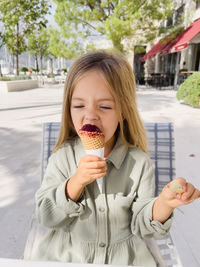 Portrait of smiling young woman holding ice cream cone