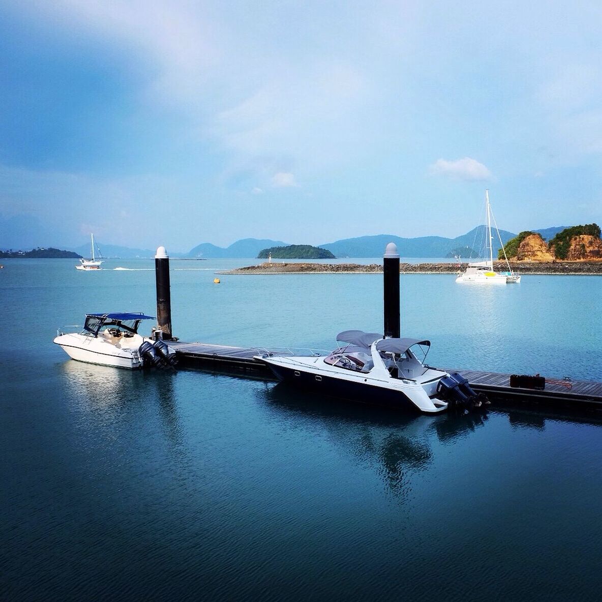 nautical vessel, water, transportation, boat, mode of transport, moored, sky, reflection, waterfront, lake, tranquility, tranquil scene, sea, harbor, blue, nature, sailboat, mast, cloud - sky, scenics