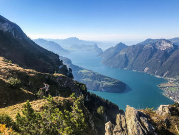 High angle view of lake and mountains against sky