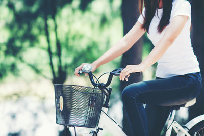 Rear view of man and woman in basket on bicycle