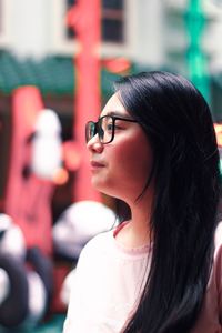 Close-up portrait of young woman looking away