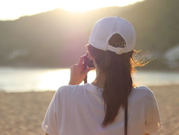 Rear view of woman wearing cap at beach