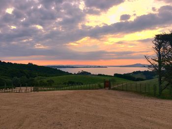 Scenic view of field against sky during sunset