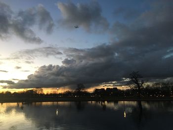 Scenic view of river against sky at sunset