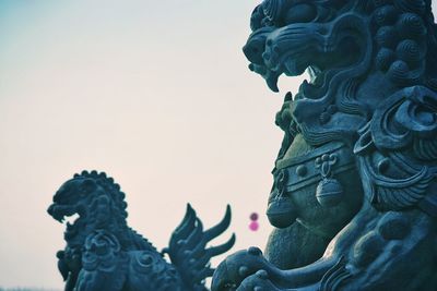 Low angle view of statue against sky