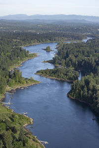 High angle view of river amidst trees against sky