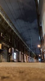 Low angle view of illuminated buildings against sky at night