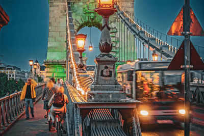 Illuminated bridge against sky at night