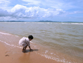 Full length of man on beach against sky