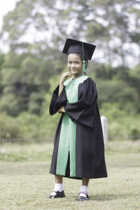 Full length of a smiling young man standing outdoors