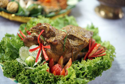 Indonesian signature grilled chicken dish served with vegetables