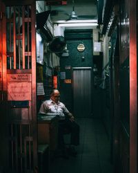 Full length of man sitting on seat