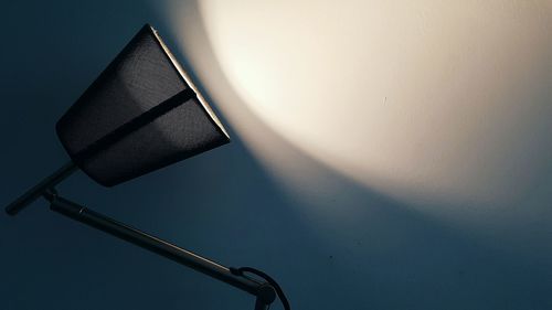 Low angle view of illuminated electric lamp against sky