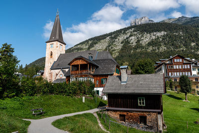 Houses by building against sky