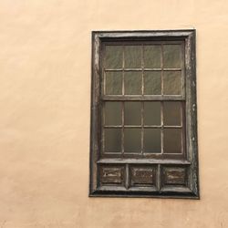 Closed wooden window by wall