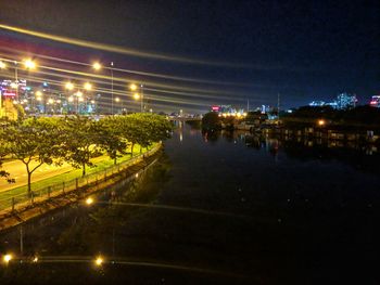 Illuminated city against sky at night