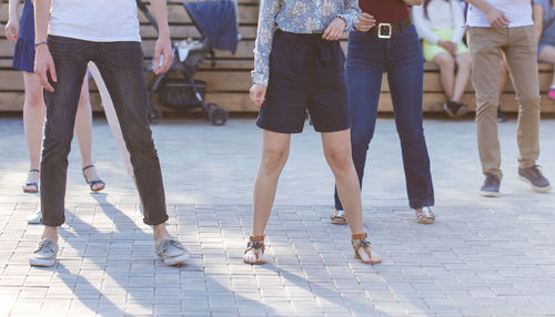 Low section of people walking on footpath