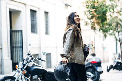 Woman riding bicycle on street in city