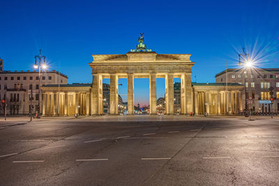 The famous brandenburg gate in berlin at night seen from the backside