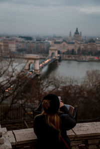 Rear view of woman looking at cityscape