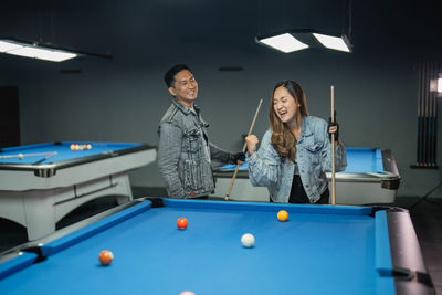 Portrait of woman playing pool