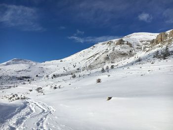 Scenic view of snowcapped mountains against sky